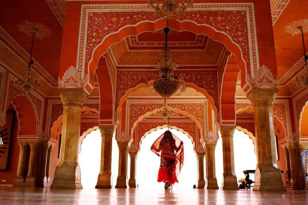 "Experience the Vibrant Colors and Culture of Rajasthan with Women in Traditional Dress at the City Palace of Jaipur."