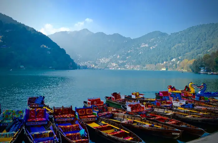 "Colorful boats lined up at the corner in Nainital - Perfect for boating activities"