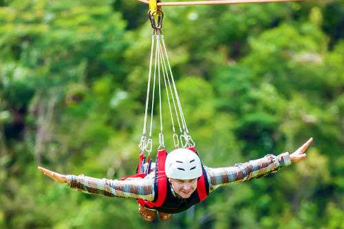 "Man enjoying zipline adventure in Rishikesh"