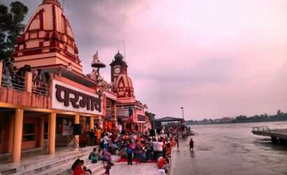 "Tourists engaging in spiritual activities and prayer at Parmarth Niketan in Rishikesh."