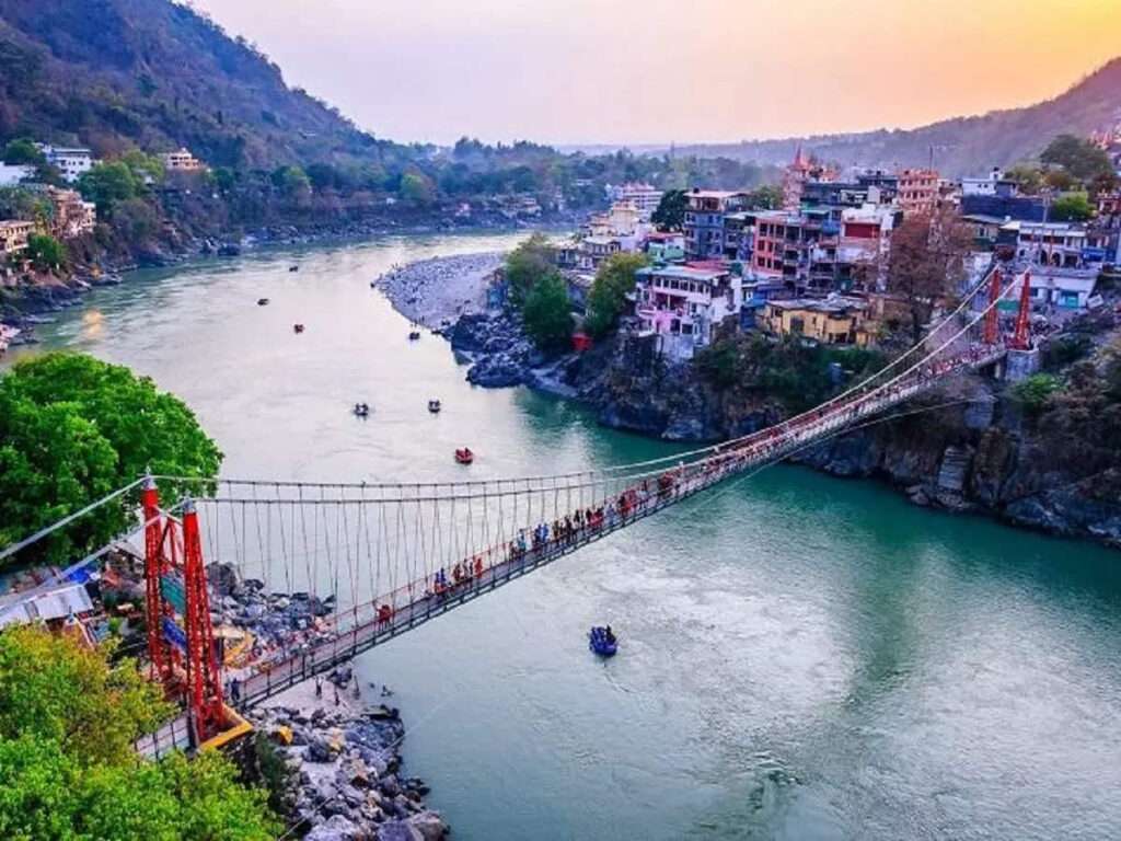 "Pedestrian bridge in Rishikesh over the flowing river - ideal spot for sightseeing and adventure activities"