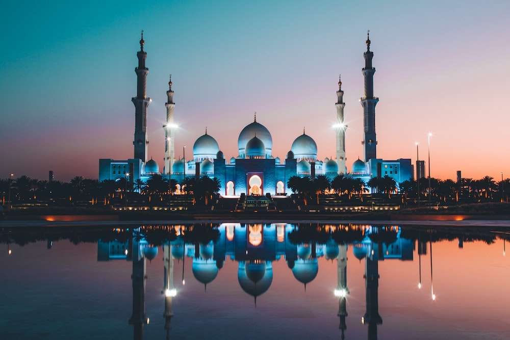 Jumeirah Mosque, an exquisite example of Islamic architecture, featuring majestic domes, minarets, and intricate geometric patterns on its pristine white facade - a symbol of cultural heritage in Dubai."