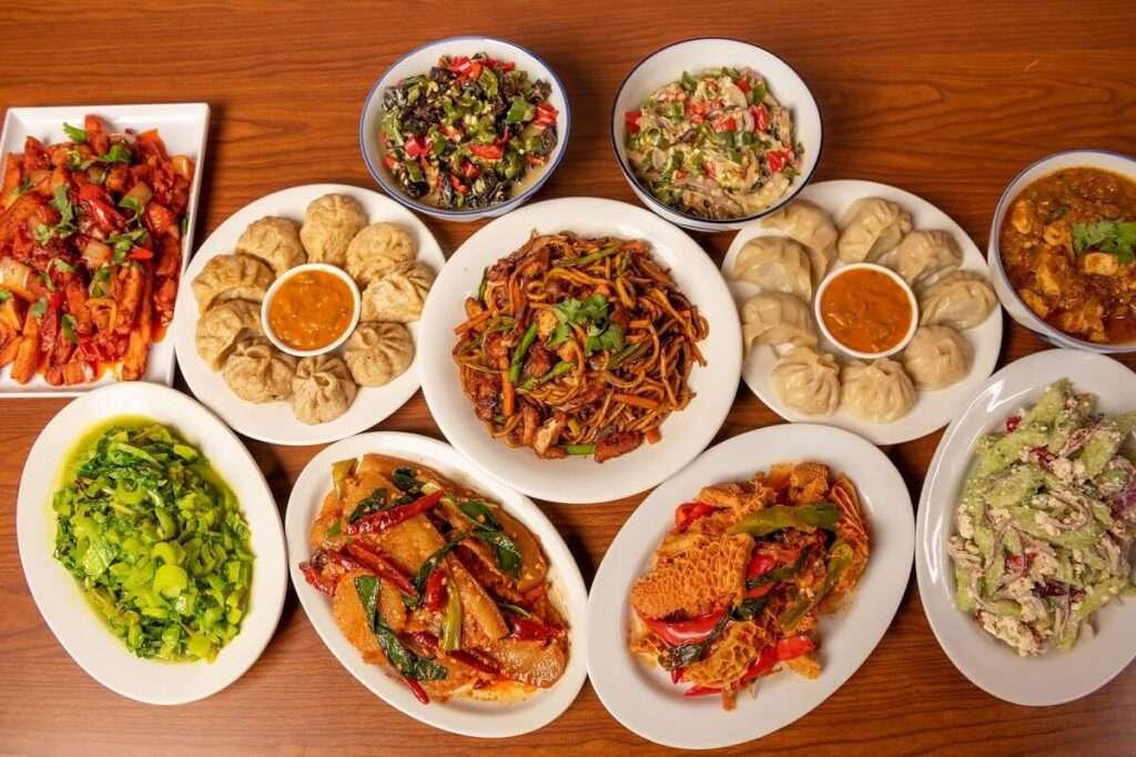 Delectable Bhutanese food plate on the desk - A mouthwatering assortment of traditional Bhutanese dishes, beautifully presented, showcasing the vibrant flavors and unique culinary heritage of Bhutan."