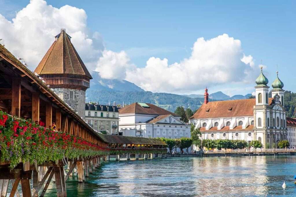 "Chapel Bridge in Switzerland: Iconic Wooden Bridge over the Reuss River with Historic Charm"