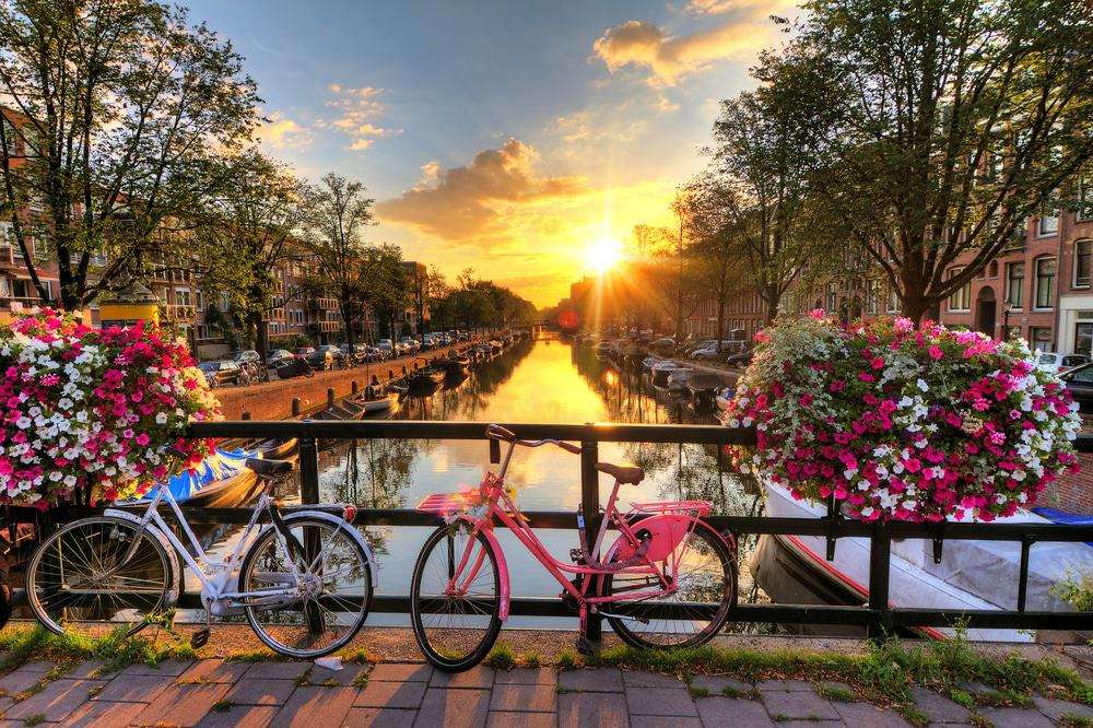 "Canals of Amsterdam: Serene waterways weaving through the charming cityscape, reflecting the beauty and history of the Dutch capital."