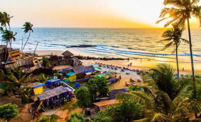 Aerial view of beaches in Goa, with people and umbrellas visible.