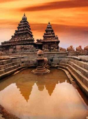 "The iconic Shore Temple in Mahabalipuram, Tamil Nadu, India - a UNESCO World Heritage site, with intricate stone carvings and sculptures depicting Hindu deities, situated on the beach with the Bay of Bengal in the background."