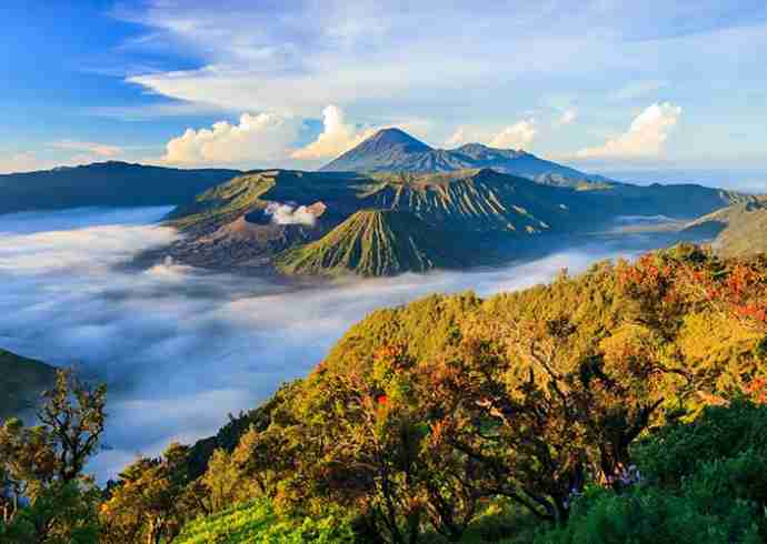 "View of Kintamani Volcano in Bali with clouds and mountains in the background"