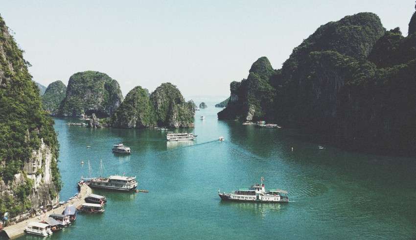 "Beautiful Hạ Long Bay Monastery surrounded by lush greenery and blue water."