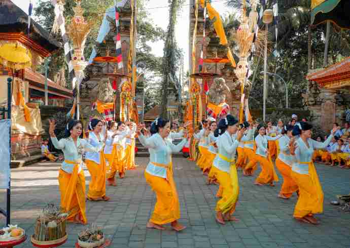 "Group of Balinese women in traditional dress performing cultural activities during Nyepi day in Bali"