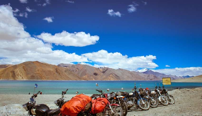 A motorcycle parked near a river in Ladakh.