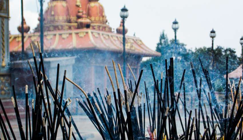 "Burning incense sticks in a temple in Sikkim, India."