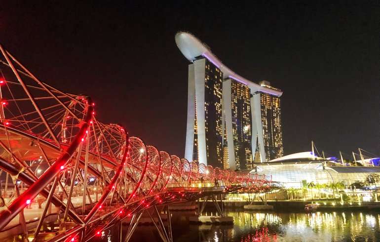 "Helix Bridge with the Marina Bay Sands in the background - a stunning view of Singapore's modern architecture."