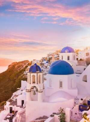 "Sunset over Santorini with pink clouds and blue domes of Greek architecture" for SEO images alt text.