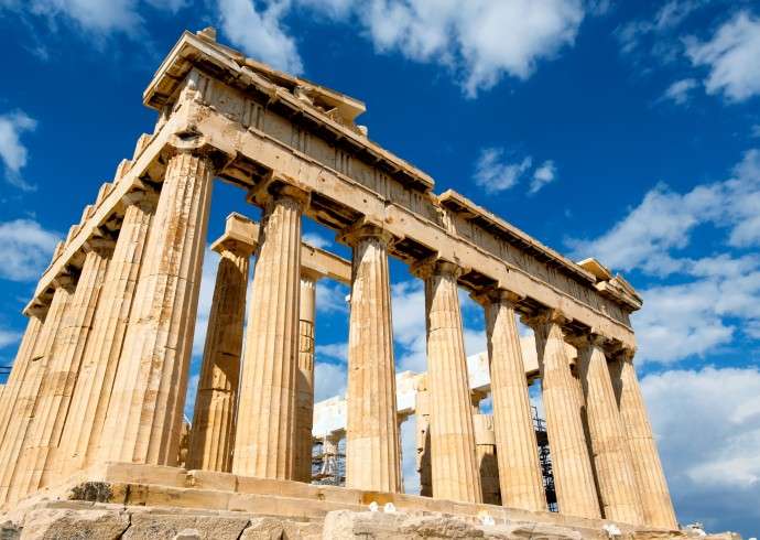 "Parthenon monument with blue sky and clouds behind in Athens"