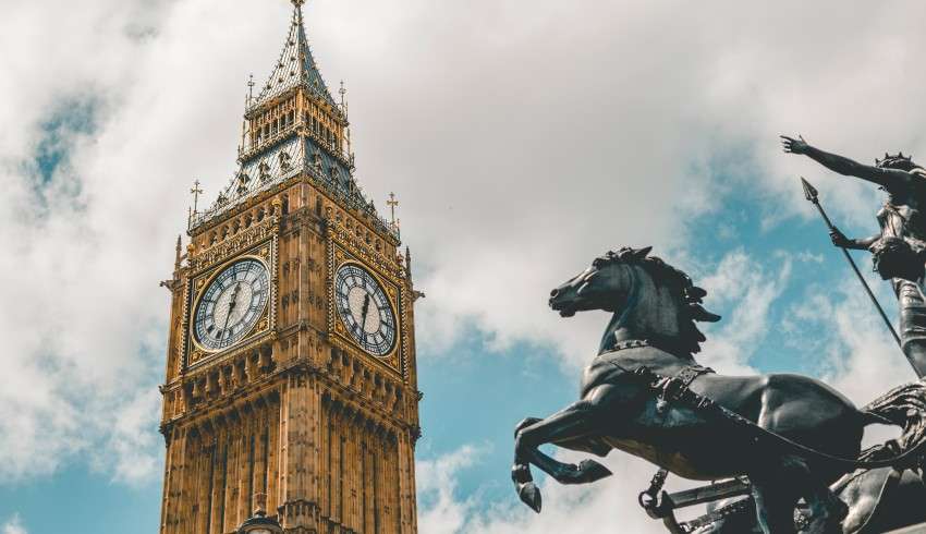 "Big Ben with black horse statue in front"