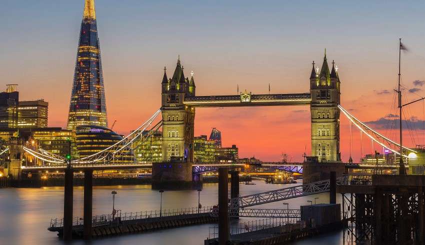 "London Bridge at sunset with pink and orange sky in the background"