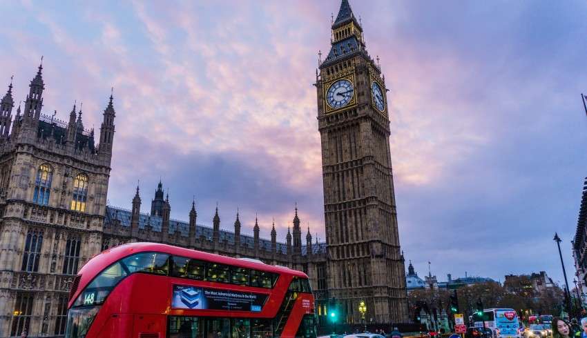 "Big Ben tower with pink sunset in the sky in London"