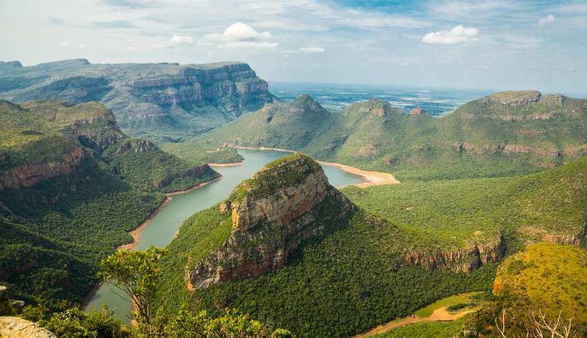 "Green jungle with a rocky cliff in the middle in South Africa" - alt text for nature-africa SEO image.