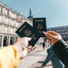 "Two hands holding a passports"